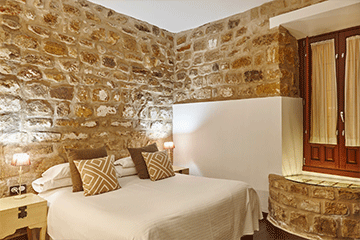 bedroom with stone walls comfortable modern hotel 6TBGZCP